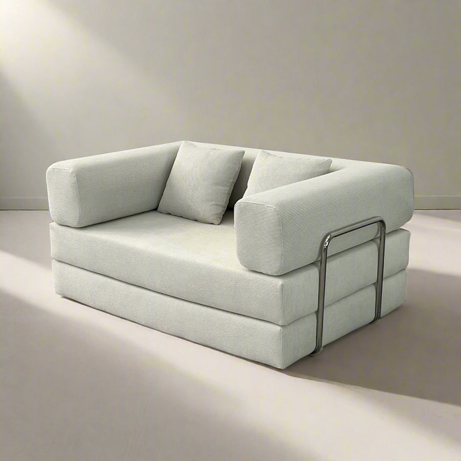 A modern gray NOVA Lounger/Sofa Bed with plush cushions and chrome-plated iron bars.